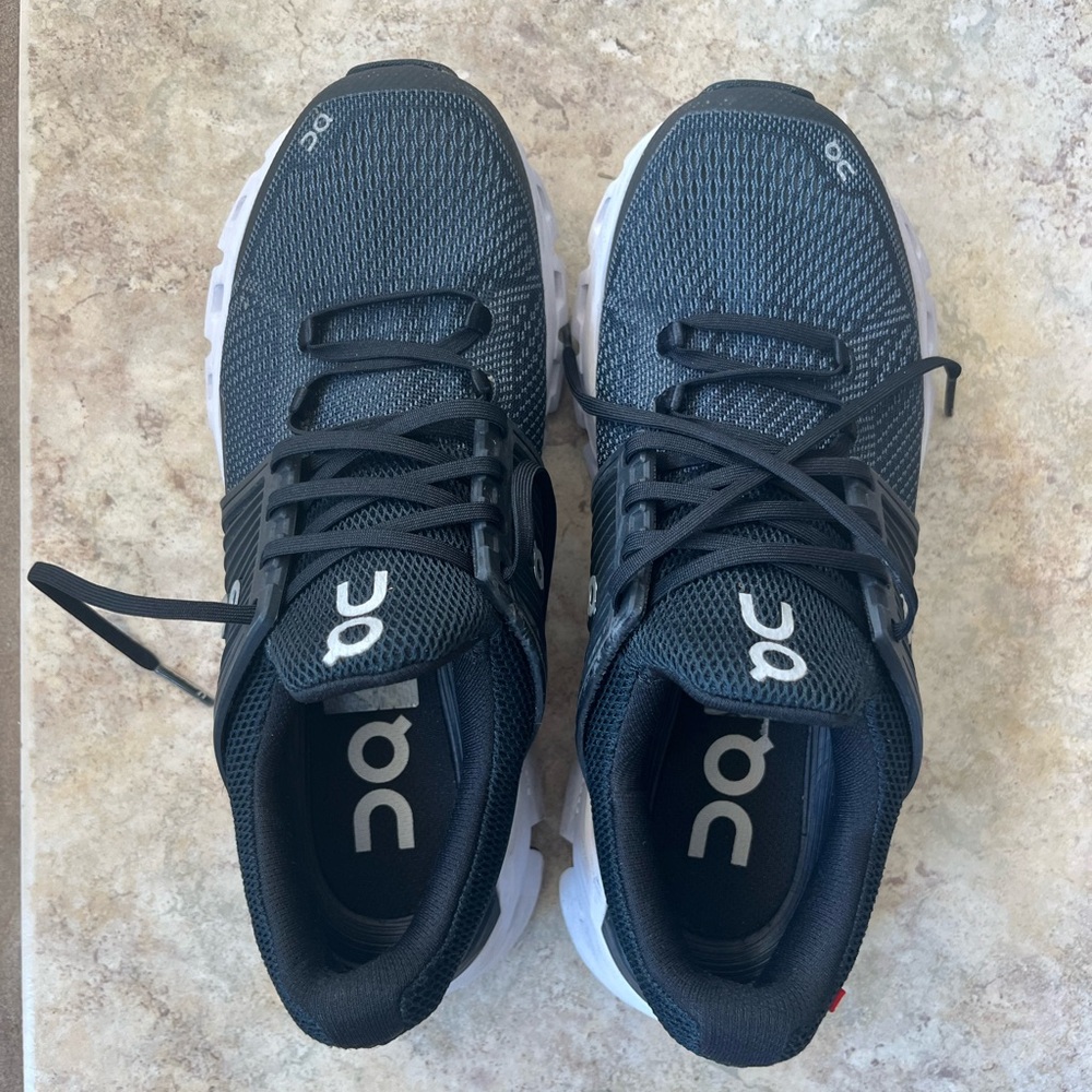 On Running Black and White Athletic Shoes with Breathable Mesh and Sleek Design